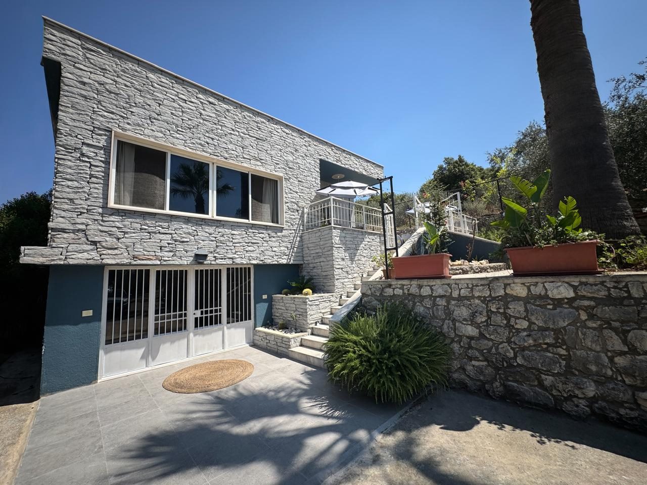 Ref (JZ10.V.41)

Fully Furnished Villa for Sale in a Quiet Area with Solar System

-City: Amchit (oubaidat)
-Land area: 970 sqm
-Built up area : 150 sqm
-Garden: 900 sqm
-Investment ratio: 25*50
-Price: 270,000$ (cash) 
- Bedrooms: 2 ( 1 Master)
- Bathrooms: 3
- Living rooms: 2
- Dining rooms: 1
- Parking spots: 6

- Features : 
*Sea View
*Mountain View
*10 minutes from jbeil town
*Quiet area
*High-end Finishing 
*Close To All Amenities 
*Calm Area
*Double Wall
*Double Glass
*AC (Installation)
*Heating systems 
*Gypsum 
*Lighting
*Used Like New 
*Fully Furnished 
*Fully Decorated 
*Storage room 
*Solar panels 15 AMP
*Water tank 6000 L

Brokerage fees: 2.5 % in case of selling / 1 month rental value in case of rent. 

For more info, kindly contact us on 71 66 55 71 / 71 788 178 or message us on WhatsApp with your full name and the reference number of the property and we will contact you the soonest.

I SOLD is a member of the Real Estate Syndicate of Lebanon (REAL)

I SOLD (Lebanon), Zalka Highway, Zalka 690 Bld. 6th Floor

فيلا مفروشة بالكامل للبيع في منطقة هادئة مع نظام طاقة شمسية

- المدينة: عمشيت (عبيدات)
- مساحة الأرض: 970 متر مربع
- مساحة البناء: 150 متر مربع
- الحديقة: 900 متر مربع
- نسبة الاستثمار: 25*50
- السعر: 270,000 دولار (نقداً)
- غرف النوم: 2 (واحدة منها رئيسية/ماستر)
- الحمامات: 3
- غرف المعيشة: 2
- غرفة طعام: 1
- مواقف السيارات: 6

- الميزات:
* إطلالة على البحر
* إطلالة على الجبل
* تبعد 10 دقائق عن مدينة جبيل
* منطقة هادئة
* تشطيبات راقية وعالية الجودة
* قريبة من جميع الخدمات والمرافق
* جدران مزدوجة (عازلة)
* زجاج مزدوج
* تمديدات مكيفات هواء
* أنظمة تدفئة
* ديكورات جبسية
* إضاءة مميزة
* حالة العقار: مستعملة كالجديدة
* مفروشة بالكامل
* مجهزة بالكامل بالديكورات
* غرفة تخزين
* ألواح طاقة شمسية (قدرة 15 أمبير)
* خزان مياه سعة 6000 لتر

رسوم الوساطه في حاله البيع ٢٫٥ ٪ وقيمة شهر في حالة الإيجار 

للمزيد من المعلومات، يرجى الاتصال بنا على  (71788178)(96171665571+) أو مراسلتنا على الواتساب مع الإسم الكامل والرقم المرجعي للعقار وسنتواصل معك في أقرب وقت

شركة  ( أي سولد )  عضو في نقابه الوسطاء والاستشاريين العقاريين في لبنان	 